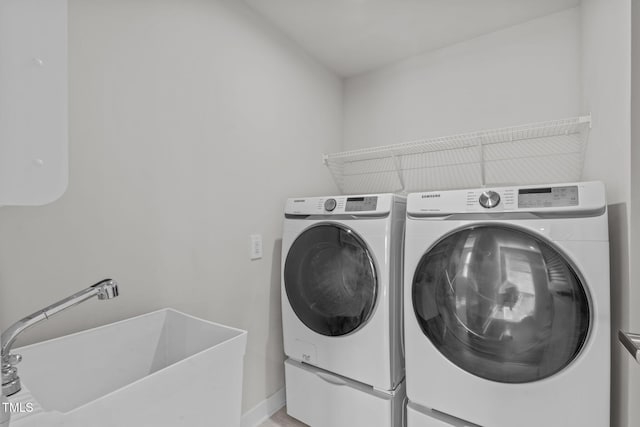 laundry area with sink and independent washer and dryer