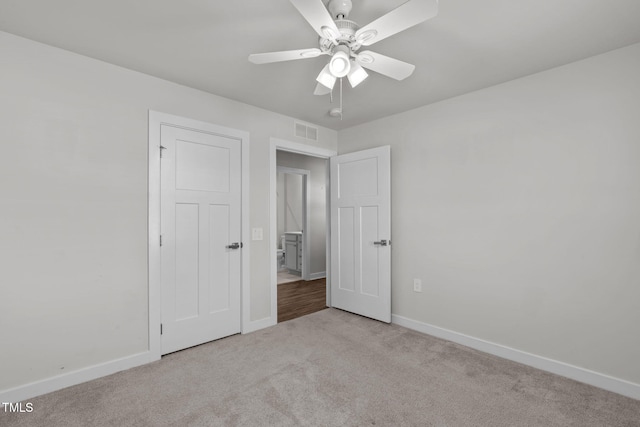 unfurnished bedroom featuring light colored carpet and ceiling fan