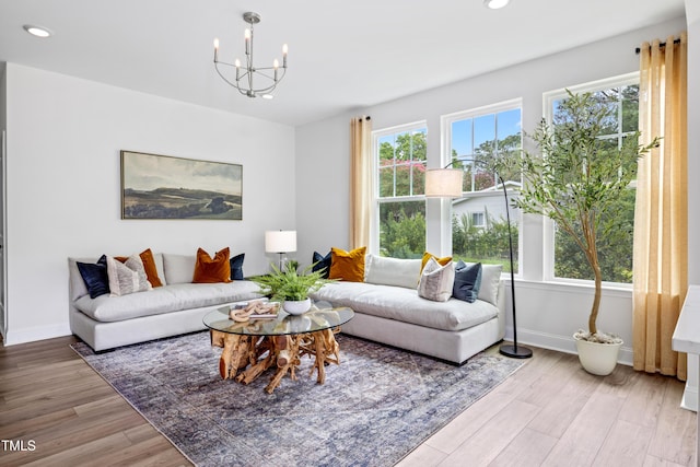 living room with hardwood / wood-style flooring and an inviting chandelier