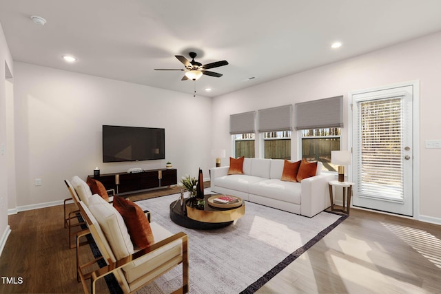 living room featuring ceiling fan and hardwood / wood-style flooring