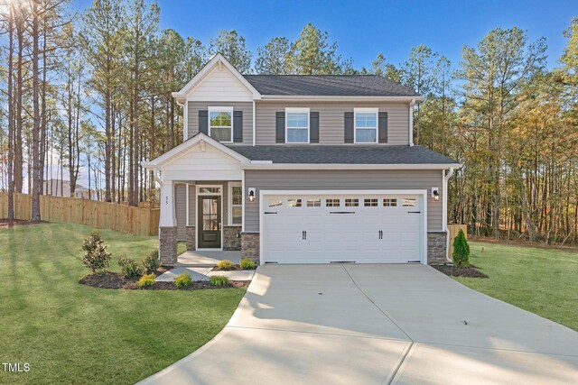 view of front of property with a garage and a front lawn