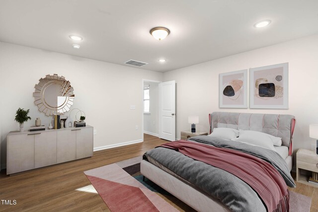 bedroom with dark hardwood / wood-style flooring