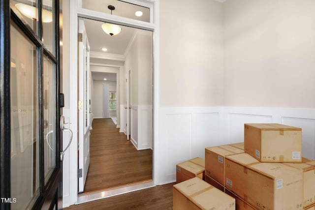 corridor with dark hardwood / wood-style floors and ornamental molding