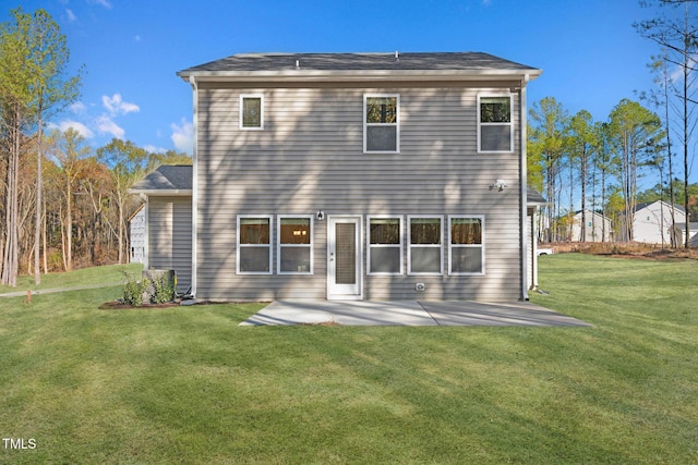 back of property with a patio area and a yard