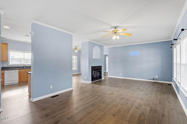 unfurnished living room with ceiling fan, sink, dark hardwood / wood-style floors, and crown molding