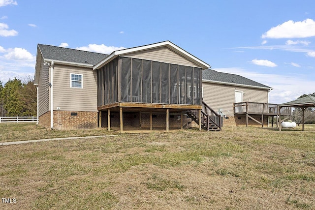 back of house featuring a sunroom, a gazebo, and a lawn