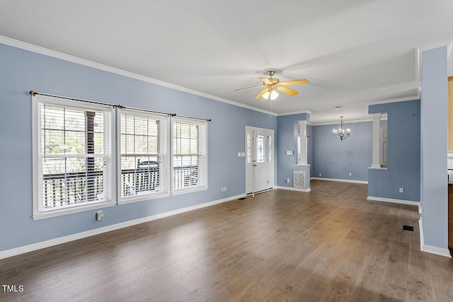 spare room with ceiling fan with notable chandelier, ornamental molding, and a healthy amount of sunlight