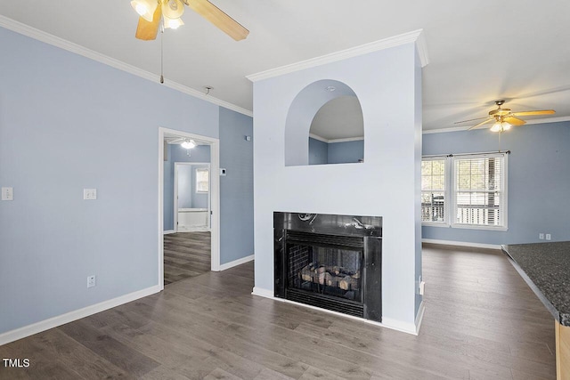 living room featuring ceiling fan, ornamental molding, a fireplace, and hardwood / wood-style flooring