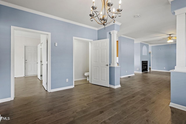 unfurnished living room with dark wood-type flooring, ornate columns, crown molding, and ceiling fan with notable chandelier