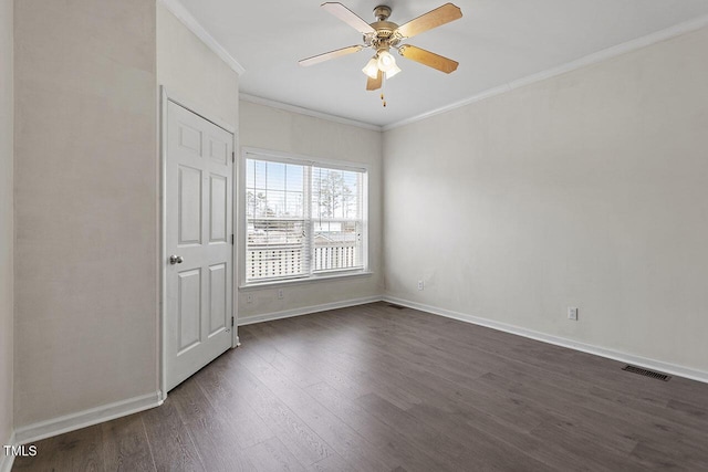 spare room with ceiling fan, dark hardwood / wood-style floors, and ornamental molding