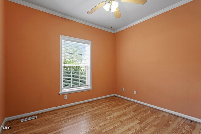 empty room with ceiling fan, light hardwood / wood-style flooring, and crown molding