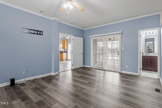 empty room featuring ceiling fan, sink, dark hardwood / wood-style floors, and ornamental molding