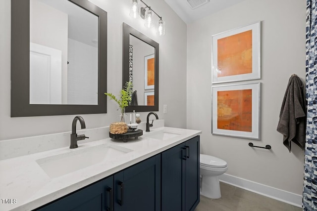 bathroom featuring vanity, tile patterned floors, and toilet