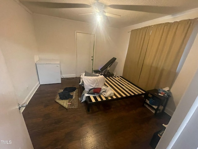 misc room featuring ceiling fan, dark hardwood / wood-style floors, and a textured ceiling