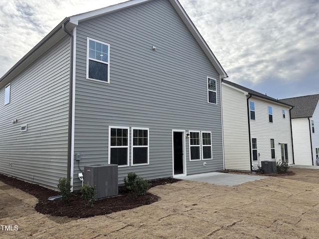 rear view of house with a patio area and central air condition unit