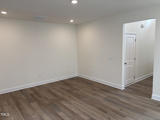 empty room with dark hardwood / wood-style flooring