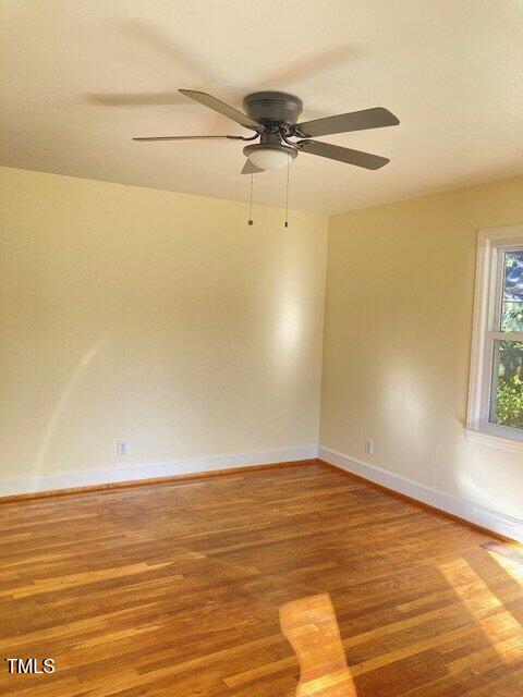 empty room featuring hardwood / wood-style flooring and ceiling fan