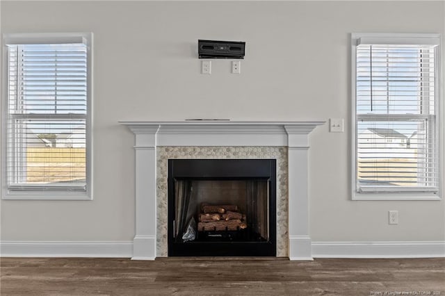 interior details featuring hardwood / wood-style floors and a tiled fireplace