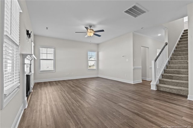 unfurnished living room with ceiling fan and dark hardwood / wood-style floors