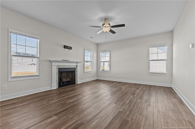 unfurnished living room with ceiling fan, plenty of natural light, and hardwood / wood-style floors