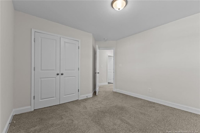 unfurnished bedroom with a closet and light carpet