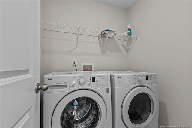 washroom featuring washer and clothes dryer