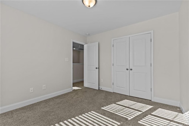 unfurnished bedroom featuring a closet and dark carpet