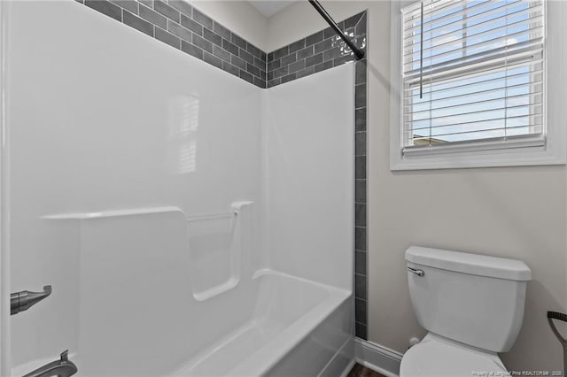 bathroom with toilet and shower / bathing tub combination