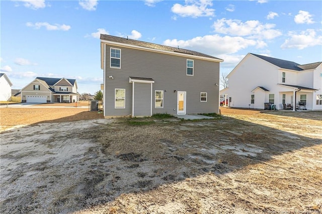 rear view of property with central AC unit