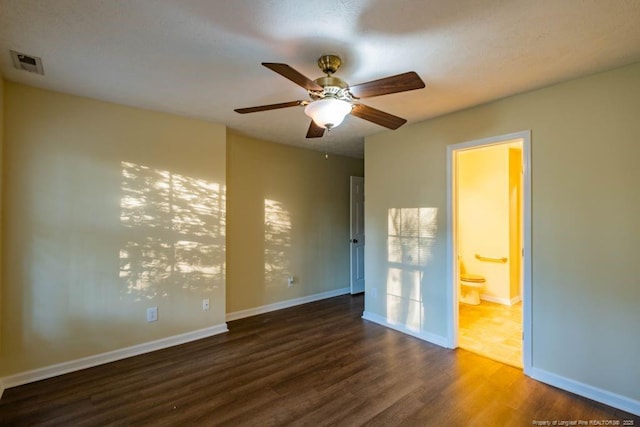 unfurnished room featuring ceiling fan and dark hardwood / wood-style floors