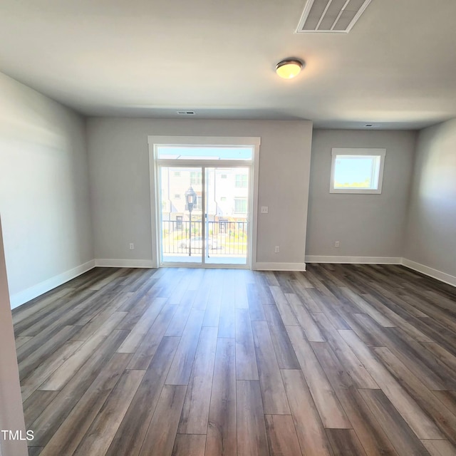 spare room featuring dark hardwood / wood-style floors