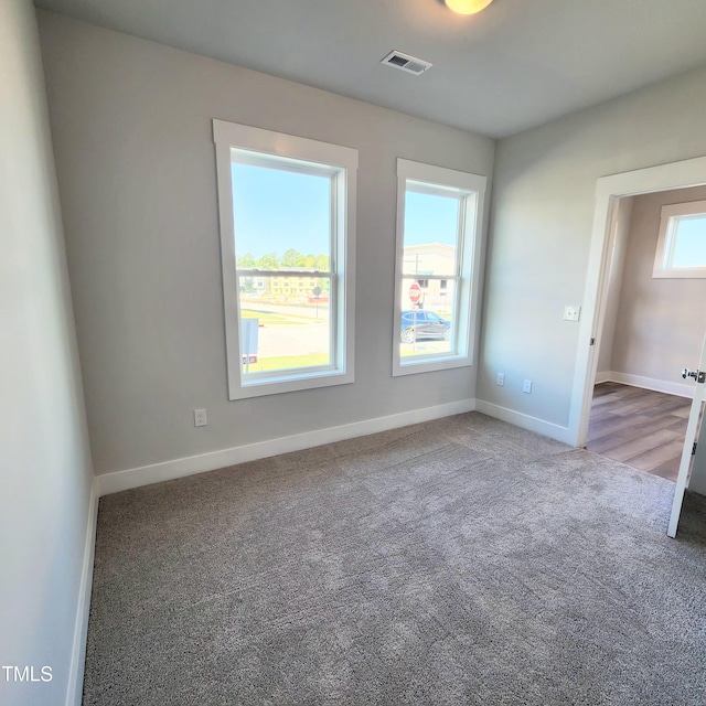 unfurnished room featuring carpet flooring