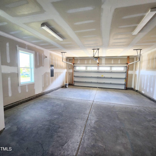 garage featuring electric panel and a garage door opener