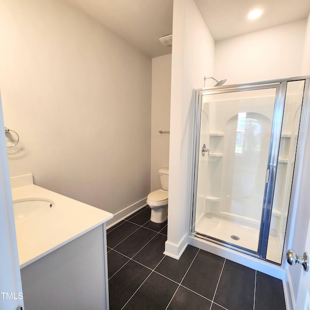 bathroom featuring tile patterned floors, a shower with door, toilet, and vanity