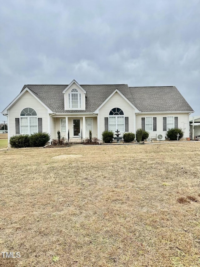 view of front facade with a front yard and covered porch