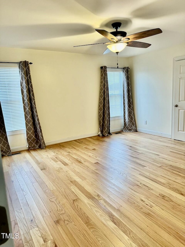 spare room with ceiling fan and light hardwood / wood-style flooring