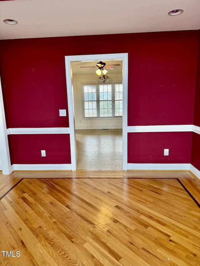 spare room featuring ceiling fan and hardwood / wood-style floors