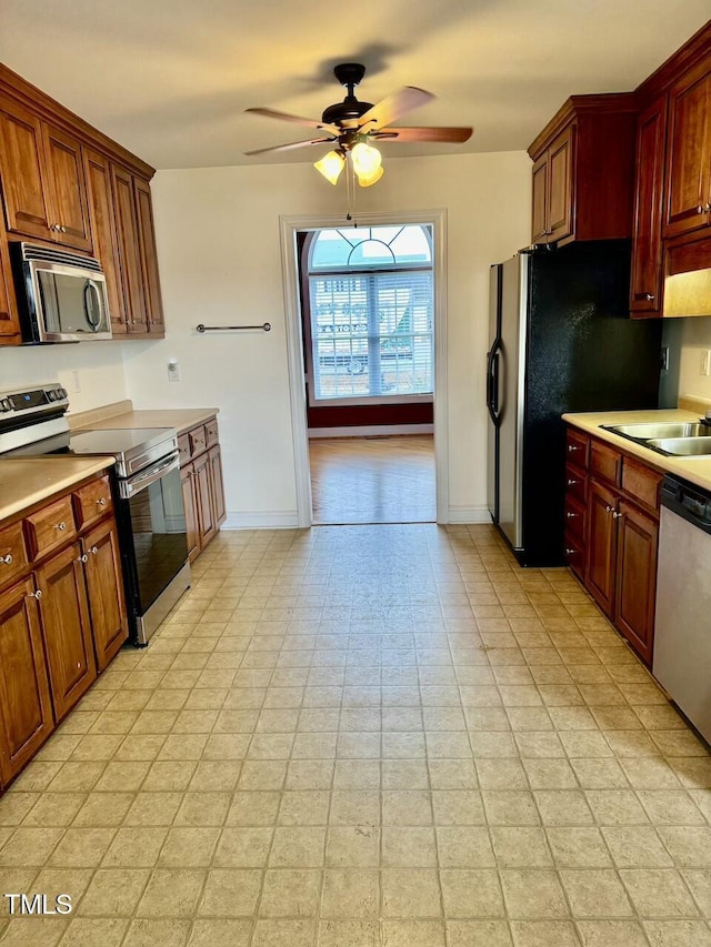 kitchen with ceiling fan, stainless steel appliances, and sink