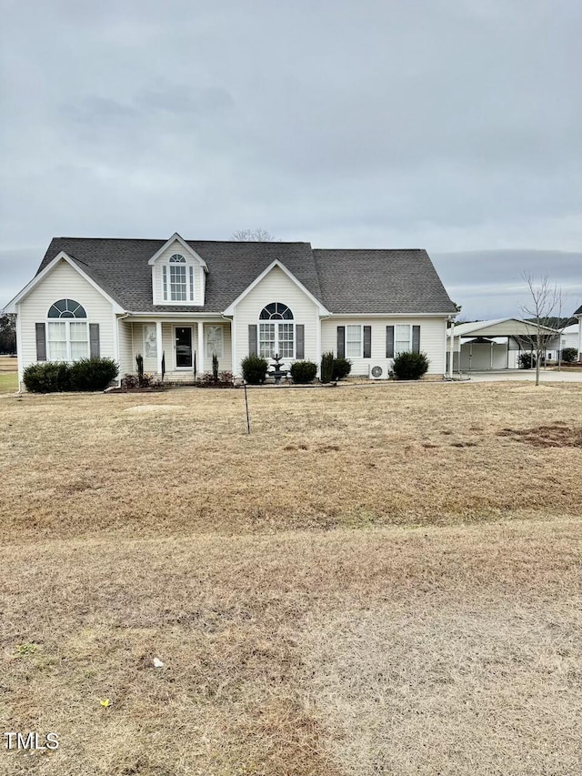 view of front of house featuring a front lawn and a carport