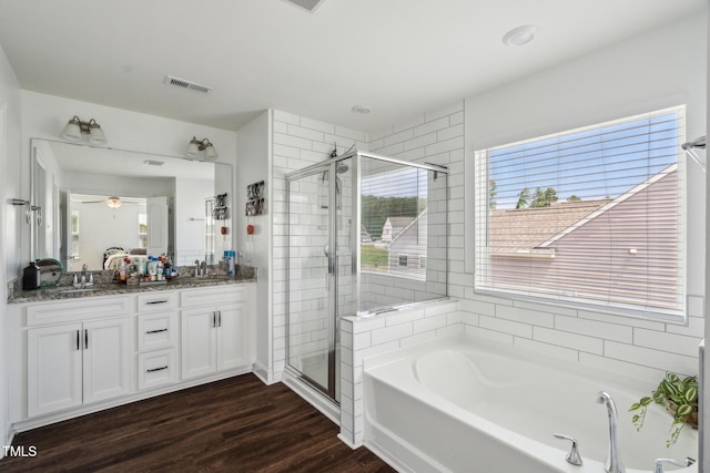 115 Bourne Dr, Franklinton, NC 27525 - bathroom featuring a shower stall, a garden tub, double vanity, wood finished floors, and a ceiling fan