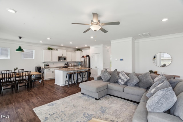 115 Bourne Dr, Franklinton, NC 27525 - living area with a ceiling fan, crown molding, dark wood finished floors, and recessed lighting