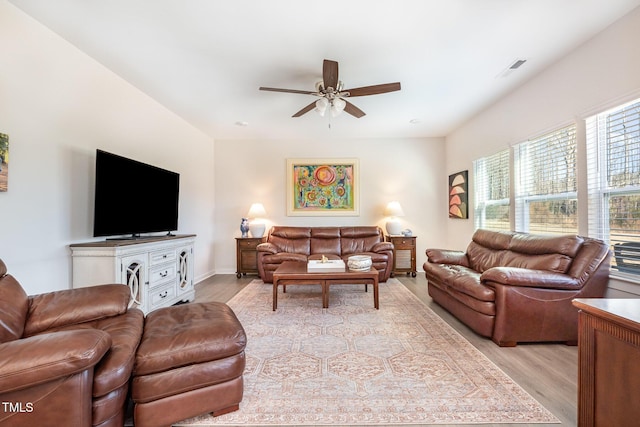 living room with ceiling fan and light hardwood / wood-style flooring