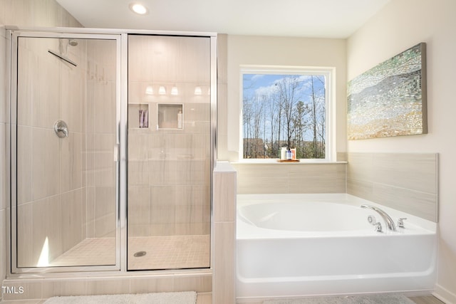 bathroom featuring separate shower and tub