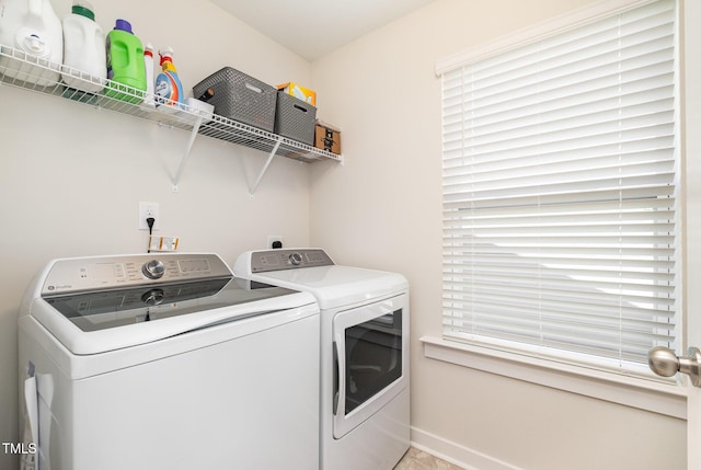 clothes washing area featuring washer and dryer