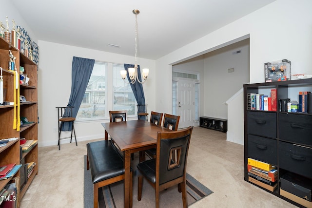 carpeted dining space featuring a notable chandelier