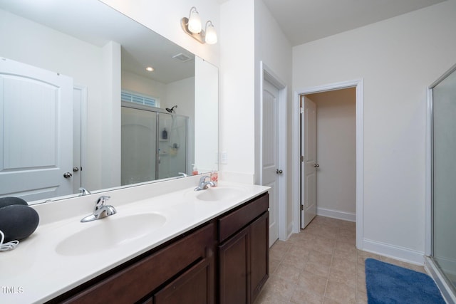 bathroom with tile patterned flooring, vanity, and an enclosed shower