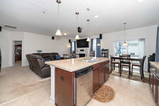 kitchen featuring sink, hanging light fixtures, dishwasher, light colored carpet, and a kitchen island with sink