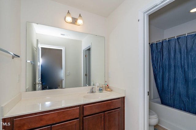 full bathroom featuring shower / bath combination with curtain, vanity, and toilet