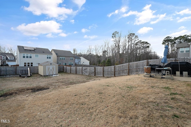 view of yard featuring a storage shed and a patio area