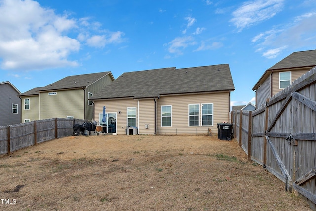 back of house featuring a lawn